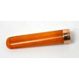 A cased 9ct rose gold-collared amber-coloured cheroot holder.