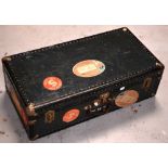 An early 20th century travel case with Cunard Shipping Line labels and various other labels.