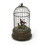 An early 20th century automaton musical box, two birds in a bird cage.