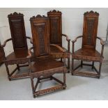 A set of four early 19th century mahogany ecclesiastical-style chairs with carved top rail over