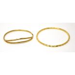 A 9ct yellow gold bangle and an 18ct yellow gold bangle, approx combined 8.4g (2).