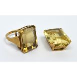 A yellow metal ring set with large emerald-cut smoky quartz stone,