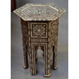 A decorative Eastern occasional table with bone and mother of pearl inlay throughout, height 41cm.