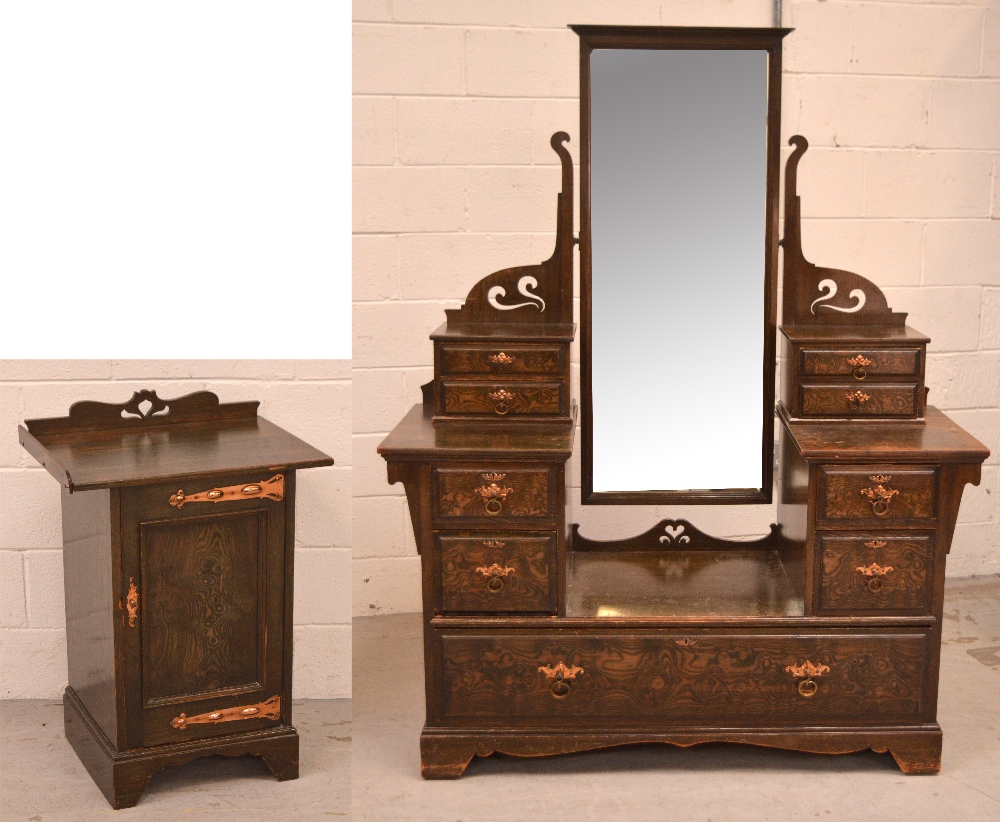 An early 20th century Arts and Crafts style stained pine two-door wardrobe, one mirrored door,