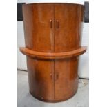 A mid-20th century walnut demi-lune shaped four-door cocktail cabinet, width 115cm.