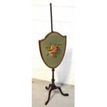 A 19th century mahogany shield-shaped pole screen, floral tapestry screen on tripod base,