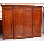 A Bridget Forester contemporary mahogany break-front triple wardrobe,