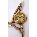 A vintage 9ct gold ladies' octagonal wristwatch, enamel and gilded dial set with Arabic numerals,
