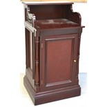 A contemporary mahogany restaurant reception desk, curved sides with carved insets,