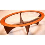 A retro G-Plan oval coffee table on abstract base, length 121cm.