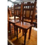 A pair of Edwardian mahogany hall chairs,