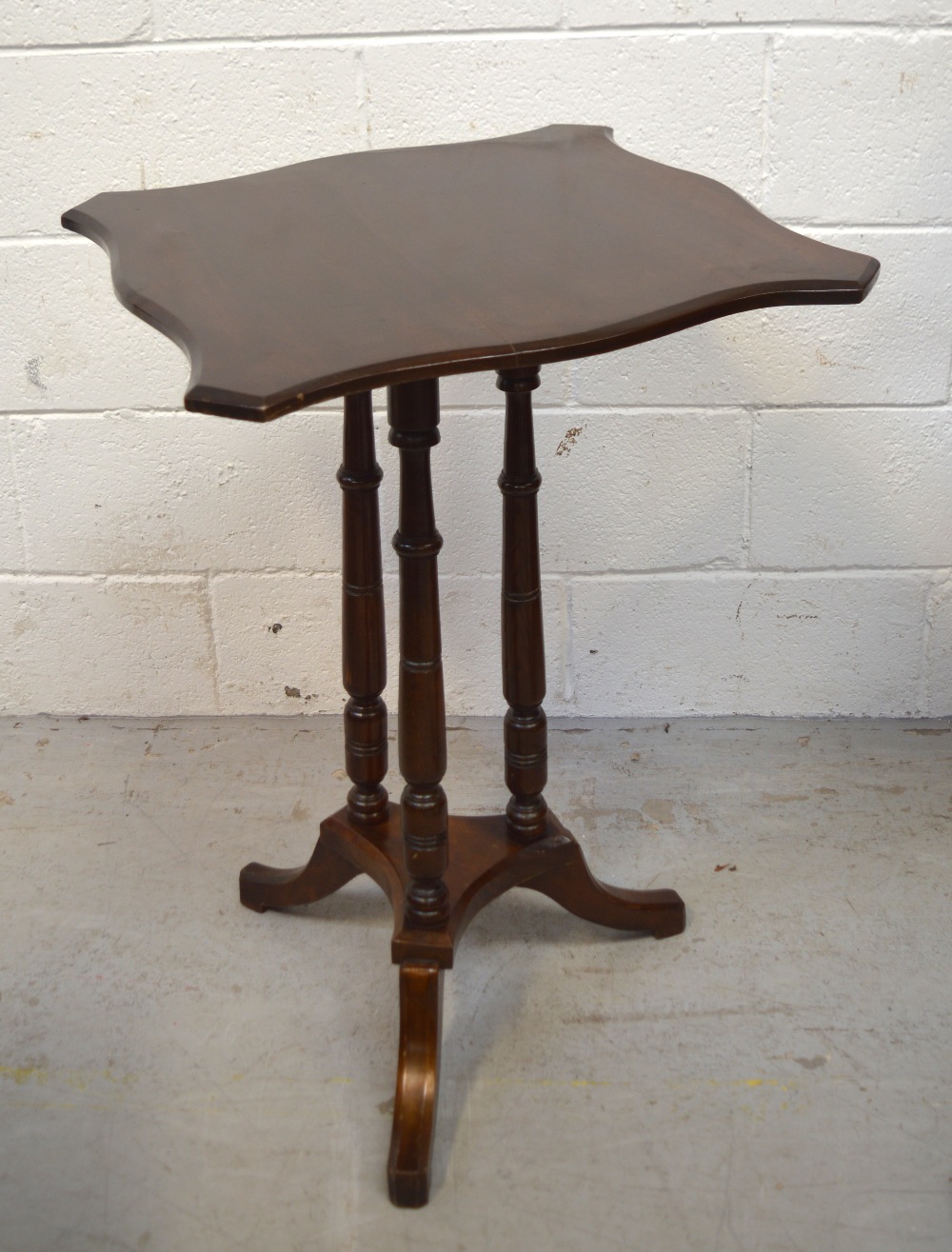A mahogany tilt-top table raised on tripod support, width 50cm.