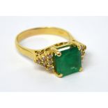 An 14ct yellow gold emerald-cut emerald ring,