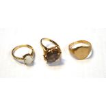 Three 9ct gold rings; one set with oval faceted smoky quartz,