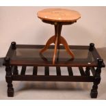 A modern mahogany rectangular glass-topped coffee table with lower slat magazine shelf on baluster