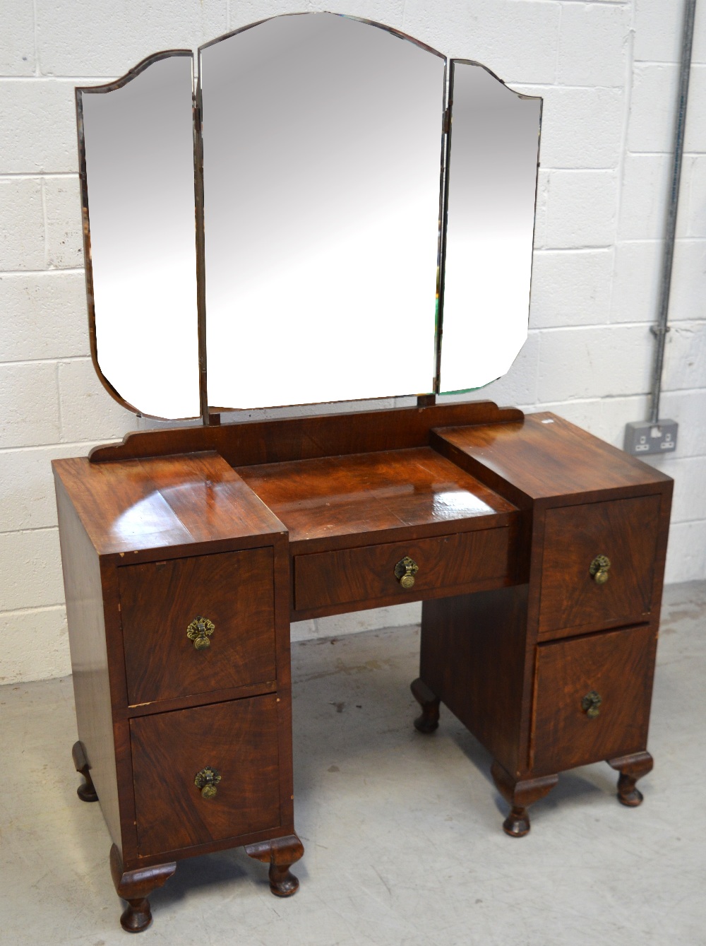 A c1950s kneehole mirror-back dressing table,