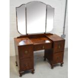 A c1950s kneehole mirror-back dressing table,