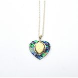 A silver abalone shell and carved bone cameo necklace with heart-shaped pendant.