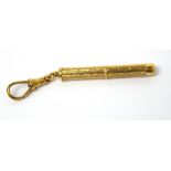 A 9ct yellow gold engine-turned retractable toothpick on suspension clip, approx 7.1g.