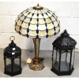 A Tiffany-style table lamp and two modern candle holders in the form of lanterns (3).