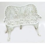 A white painted aluminium garden bench of slight kidney shaped form with pierced decoration.