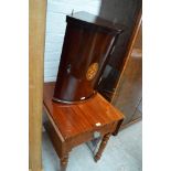 A reproduction mahogany corner cupboard with central oval inlaid panel with dentil moulding to the