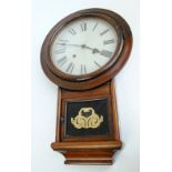 A late 19th century American wall clock with painted dial set with Roman numerals and glazed door,