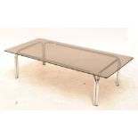 A smoked glass topped chromed tubular legged coffee table.