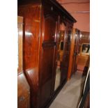A large Edwardian mahogany three door wardrobe with label inscribed 'Wylie & Lochhead Ltd Glasgow'.
