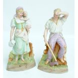 A pair of German Gebruder Heubach tinted bisque figures of a man with an axe and a woman with a