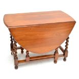 An early 20th century oval drop leaf gate leg table with barley twist and block supports,