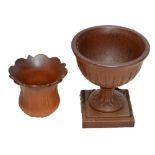 A Victorian terracotta glazed urn on square sectioned plinth,