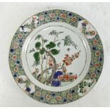 A late 18th/early 19th century Chinese porcelain Wucai style decorated circular plate painted in