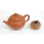 A Chinese Yixing teapot with impressed character marks to base, length 14cm,