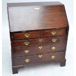 A George III mahogany bureau with two short and three long graduated drawers on bracket feet,