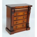 A miniature mahogany chest of five drawers, one frieze drawer and four with glass handles,