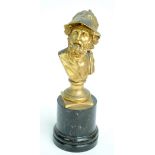 A late 19th century gilt metal bust depicting a Classical bearded gentleman wearing a helmet on