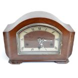 A 1930's Art Deco walnut mantel clock with shaped chapter ring set with Roman numerals, width 31cm.