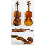 An early 20th century unnamed German violin, cased, with two-piece back, length of back 35.75cm.