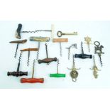 A collection of vintage corkscrews with wooden and horn handles plus some novelty brass and metal