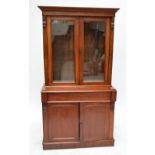 A Victorian mahogany bookcase on cupboard with plinth base.