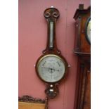 A large Victorian mahogany wheel barometer with unusual 12" silvered dial, signed Farnworth,