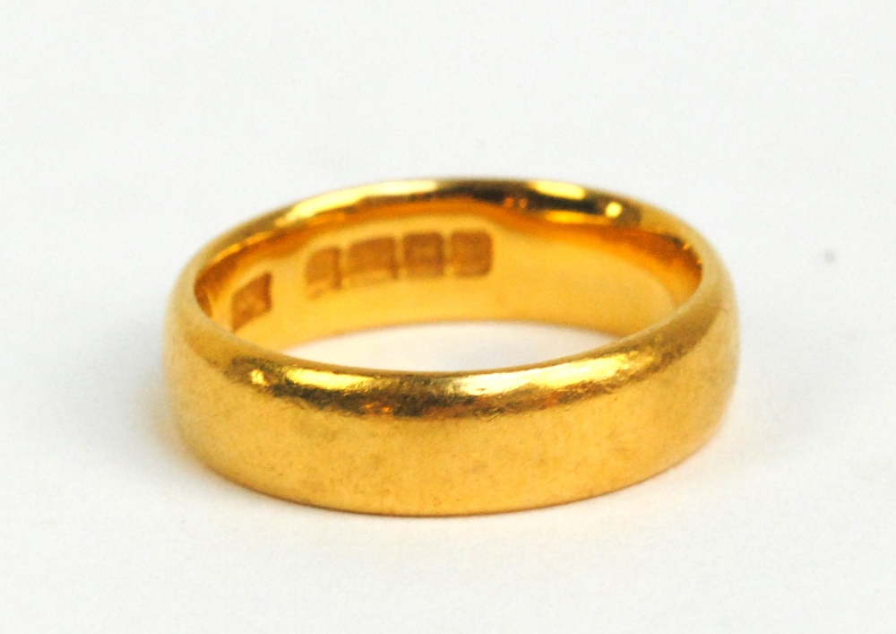 A 22ct yellow gold wedding band, size I, approx 5.6g.
