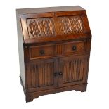 An oak linen fold decorated bureau raised on bracket feet, width 76cm.