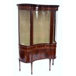 An Edwardian mahogany and a inlaid invert bowfronted display cabinet raised on square section