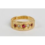 An 18ct yellow gold ring set with three small rubies and two small diamonds in starburst setting,