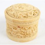 A 19th century Chinese Canton carved ivory cylindrical box decorated with chasing dragons on cloud