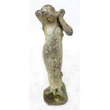 A large reconstituted stone figure of a scantily clad classical maiden, height 118cm.