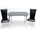 A glass topped rounded rectangular table and four contemporary dining chairs (5).