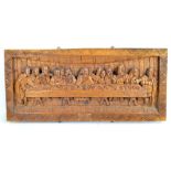 A large carved wooden panel depicting The Last Supper,